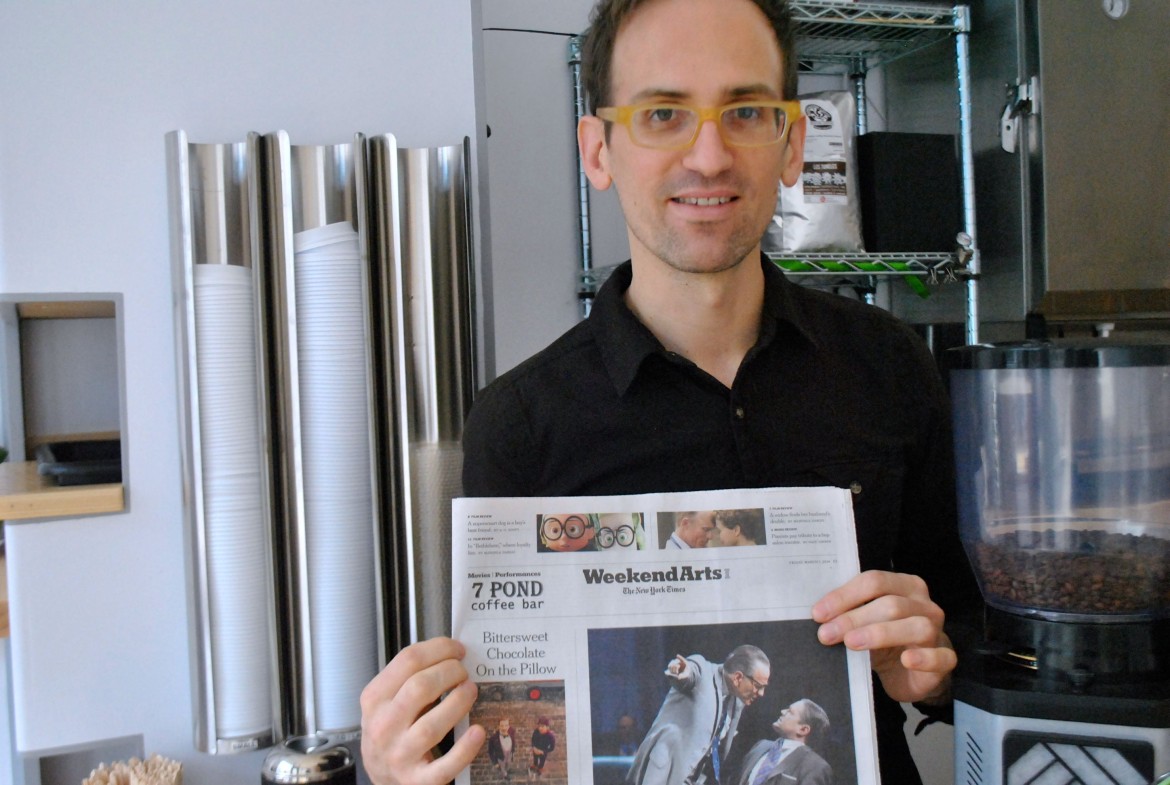 Judson MacRae of 7 Pond Coffee Bar shows off the store's way of encouraging folks not to steal the New York Times.