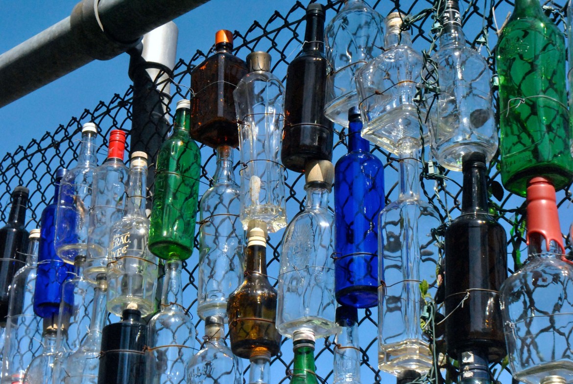 Bottles arrayed on an Everett Street backfence on Monday, April 21, 2014.