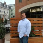 File photo: Adam Rutstein, owner of Centre Street Sanctuary, stands beside his new outdoor patio space.