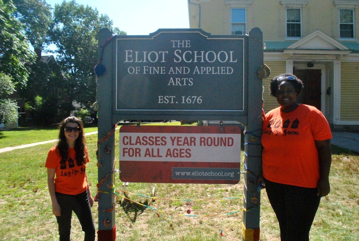 Diane Ivey, right, and Jessica Bucci "yarn-bombed" the sign at the Eliot School on Tuesday, Aug. 19, 2014.