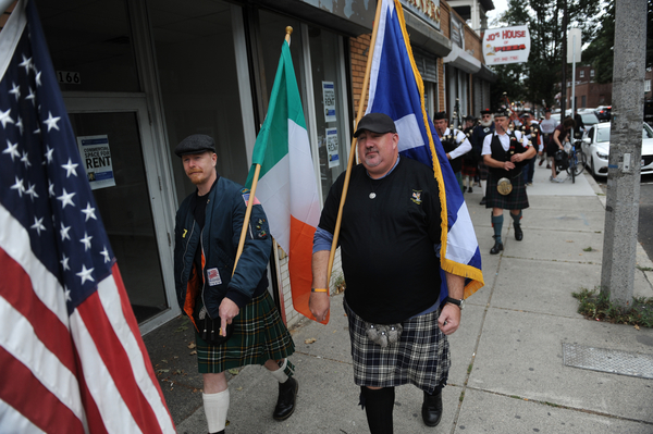 Ryan Higgins (l), of Jamaica Plain, and Dennis Napier, of Norfolk, carry the Irish and Scottish flags during the first annual "Angry Scotsman" Kilt Crawl through Jamaica Plain, Sept. 13, 2014. Participants of the event, which benefited the Scots' Charitable Society and Charitable Irish Society, stopped at four local establishments; Eugene O'Neill's, James's Gate, Costello's, and The Haven.