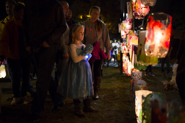 Kaitlin Jacobucci, 6, searches for a lantern to claim for herself at the Jamaica Pond Lantern Parade on Oct. 18, 2014.