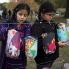 Twins Veronica (left) and Victoria, 9, light lanterns in preparation for the Jamaica Pond Lantern Parade on Oct. 18, 2014. The girls are involved in Spontaneous Celebrations’ La Piñata program, a traditional music and dance group directed by Rosalba Solis.