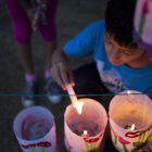 Cristian, 13, lights lanterns for the Jamaica Pond Lantern Parade on Oct. 18.