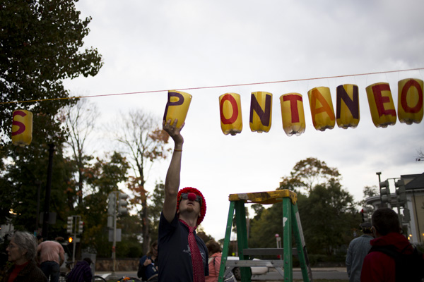 James Purtle arranges lanterns spelling out “Spontaneous Celebrations” for the Jamaica Pond Lantern Parade on Oct. 18., 2014.