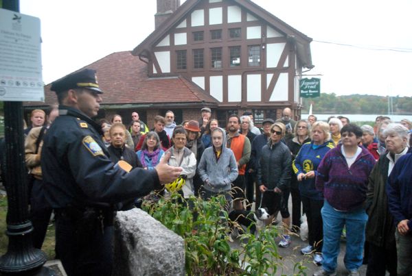 Police Capt. Alfredo Andres, left, addresses a crowd of concerned residents during an emergency community meeting on Friday, Oct. 3, 2014.