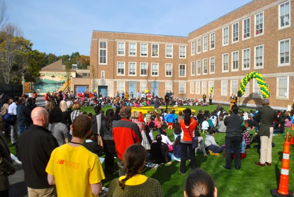 A crowd of proud parents, teachers, community members and students gathered to cut the ribbon on the new playing field at Curley K-8 School on Tuesday, Oct. 28, 2014.