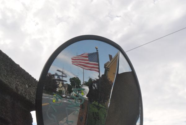 File photo: A U.S. flag flaps in a strong wind on School Street, June 25, 2014.