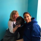 Co-owners Nancy Baxter, left, and Rebecca Wildstein love up on a visiting pup.