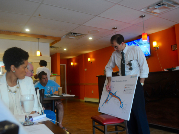 Nate Curtis, right, describes aspects of the Casey Arborway project to members of the JP Business and Professional Association during a Wednesday, July 15, 2015 meeting at Tikki Masala.