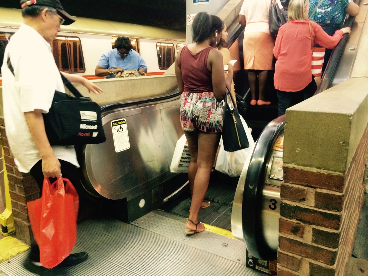 Commuters take an escalator at Forest Hills Station on Tuesday, Sept. 8, 2015.