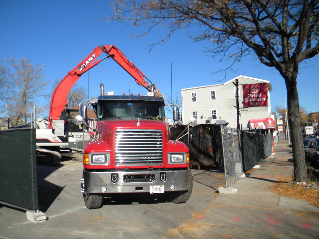 The first truckloads of debris leave the old Royal Friend Chicken site in mid-November 2015.